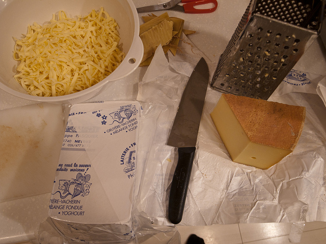 preparing grated gruyere for cheese fondue